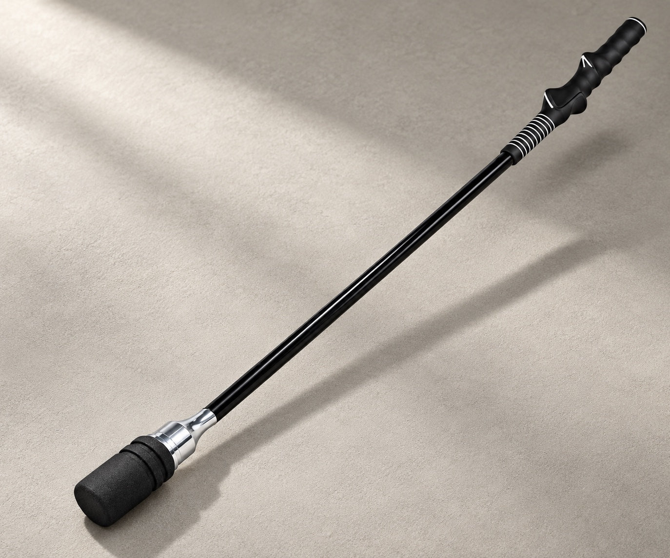 Black training stick with a shaped grip, slim shaft and padded weighted tip